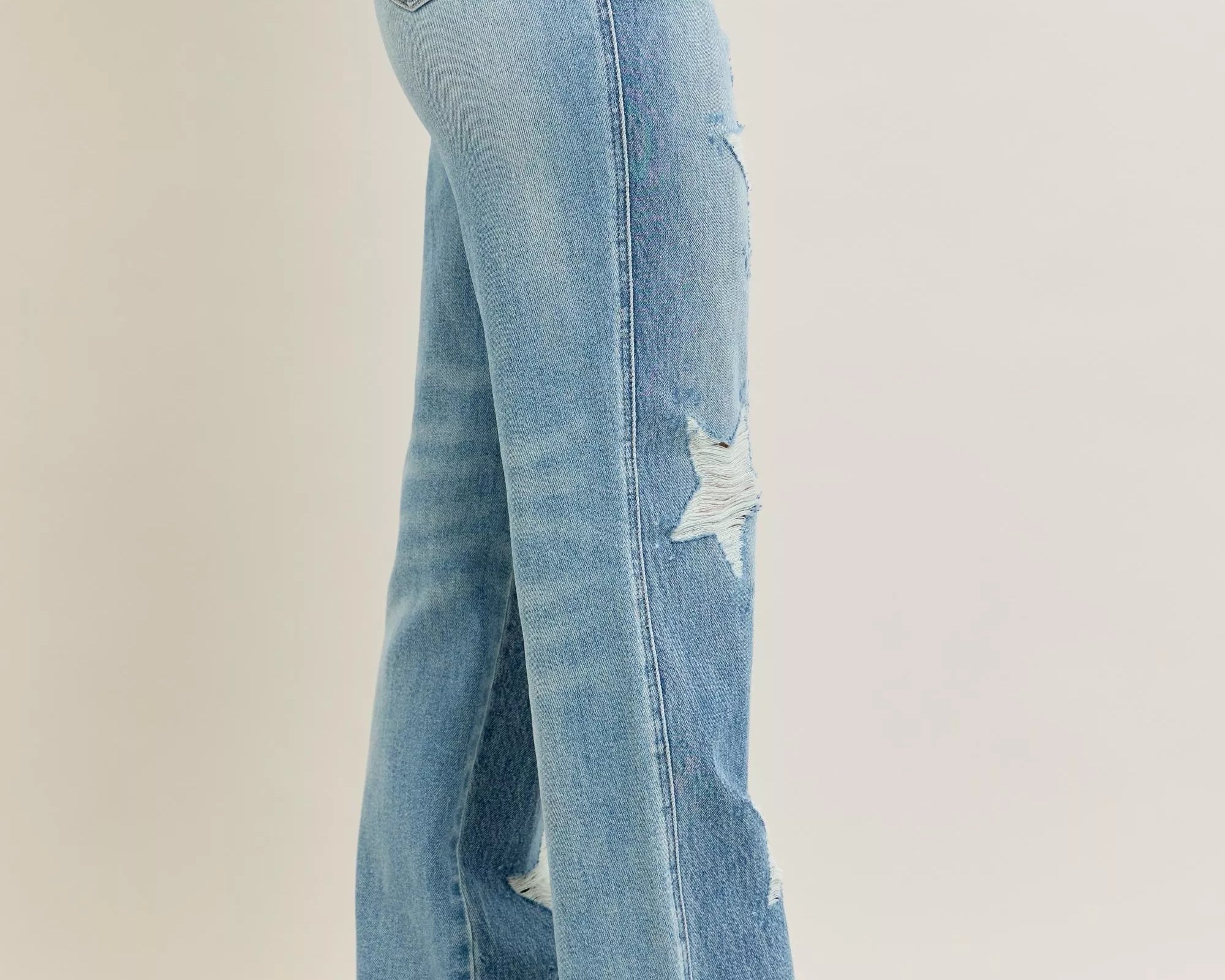 NEWYORKLISTED STYLE COLLECTION: Light blue jeans with a star design on a beige background