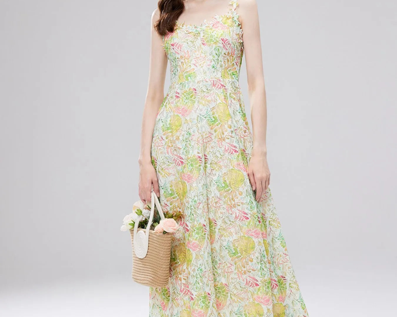 NEWYORKLISTED STYLE COLLECTION: Woman wearing a floral dress and straw hat on a gray background