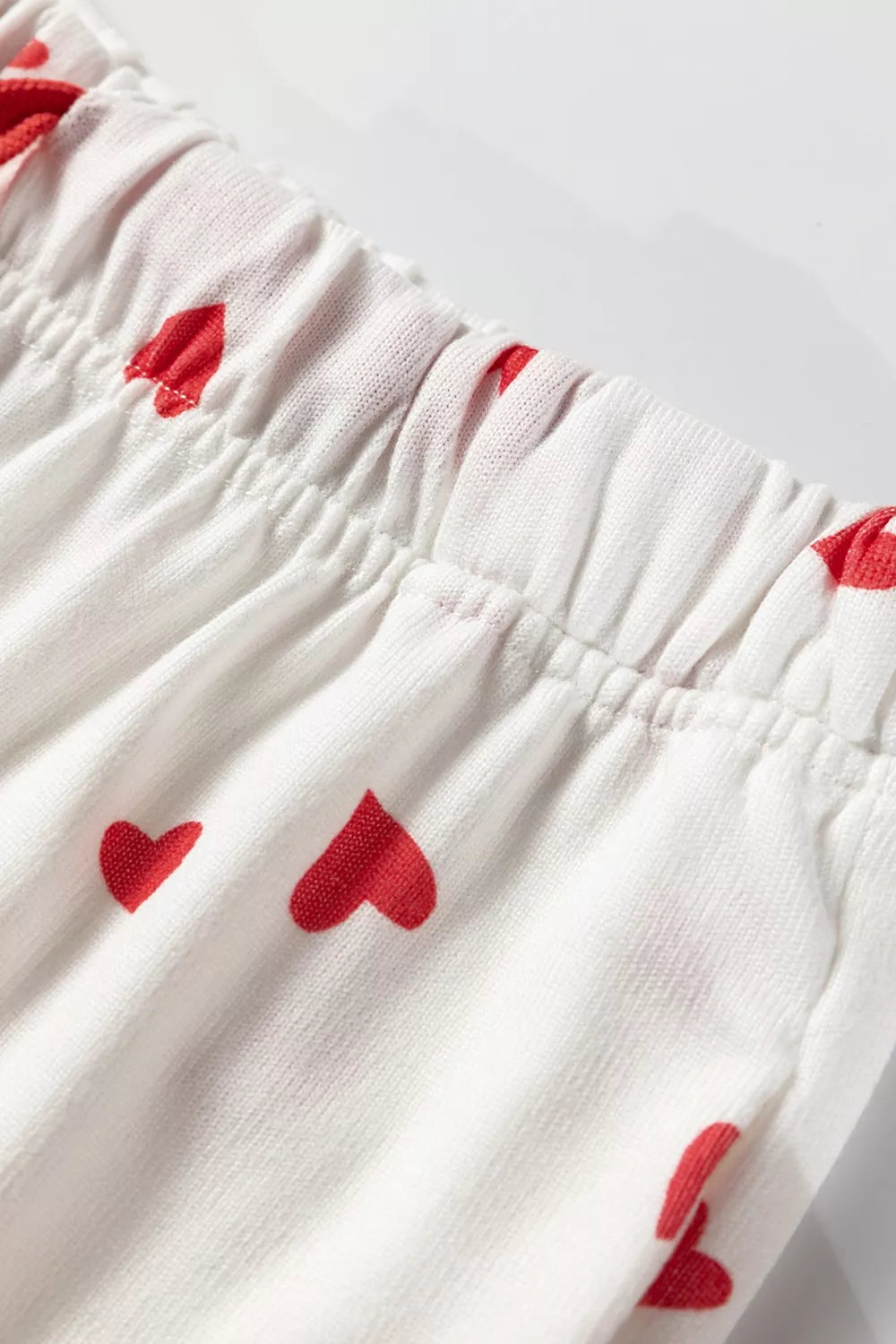 NEWYORKLISTED Intimate Apparel Collection: White fabric with red heart patterns on a light gray background