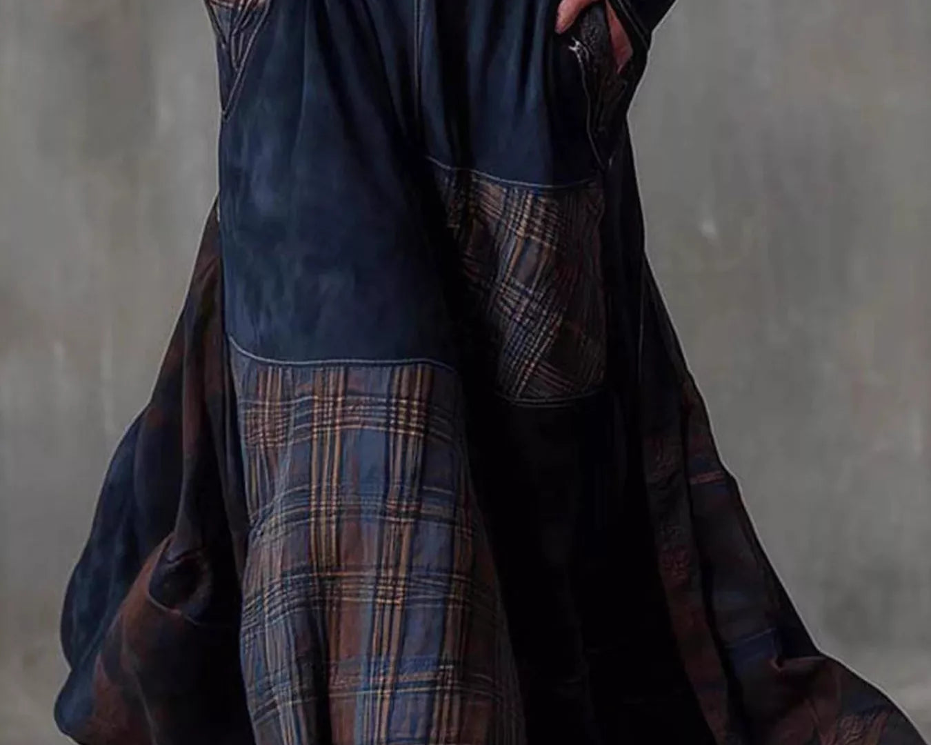 NEWYORKLISTED Style Collection: Long dark blue patchwork skirt with plaid pattern worn by a person against a gray background