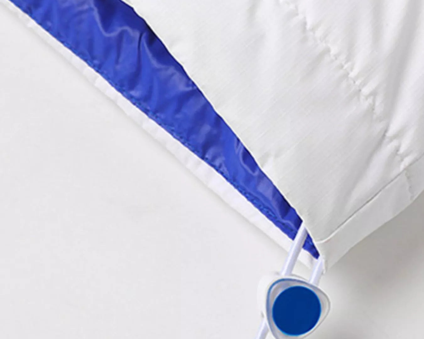 NEWYORKLISTED ATLAS MEN’S COLLECTION: White comforter with blue trim on a white background
