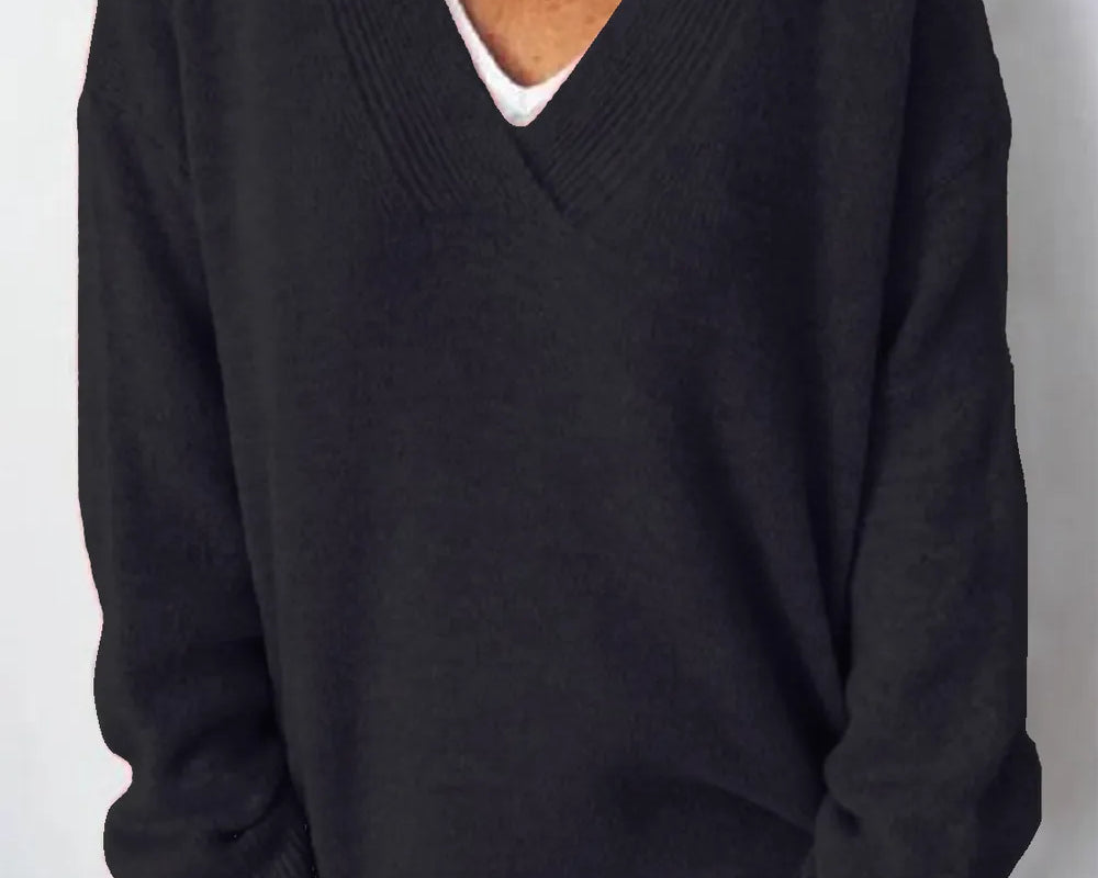 NEWYORKLISTED STYLE COLLECTION V-Neck Dropped Shoulder Sweater in soft knit black fabric on a minimalist white background