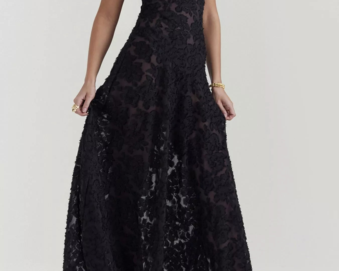 NEWYORKLISTED STYLE COLLECTION: Black lace dress worn by a model on a white background
