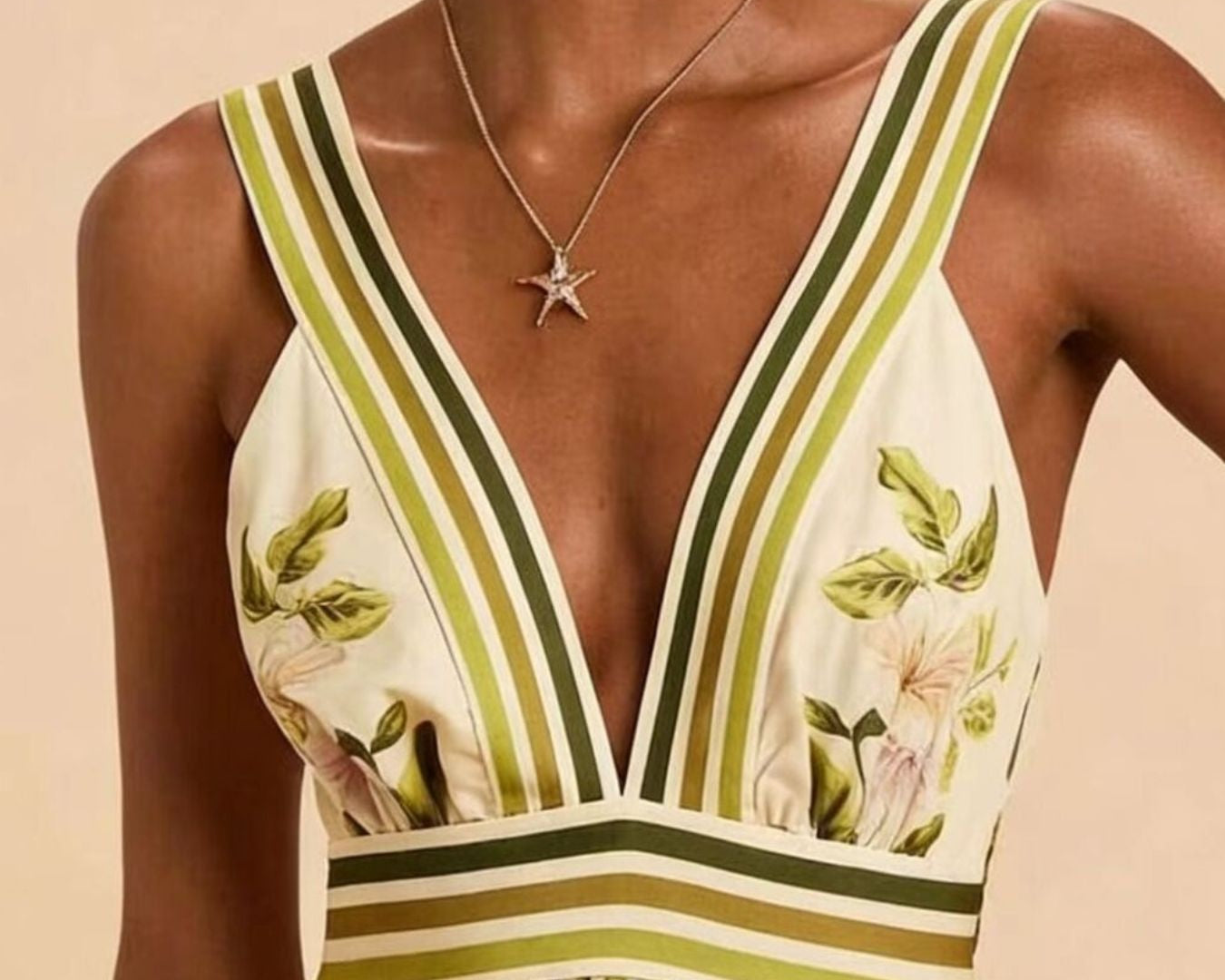 NEWYORKLISTED STYLE COLLECTION: Woman wearing a floral dress with green and yellow stripes on a beige background