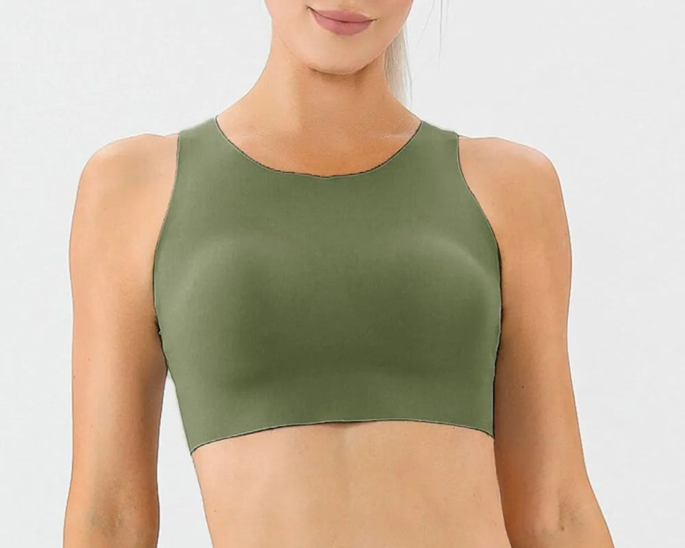 NEWYORKLISTED ACTIVEWEAR COLLECTION: Woman wearing an olive green sports bra and leggings on a white background