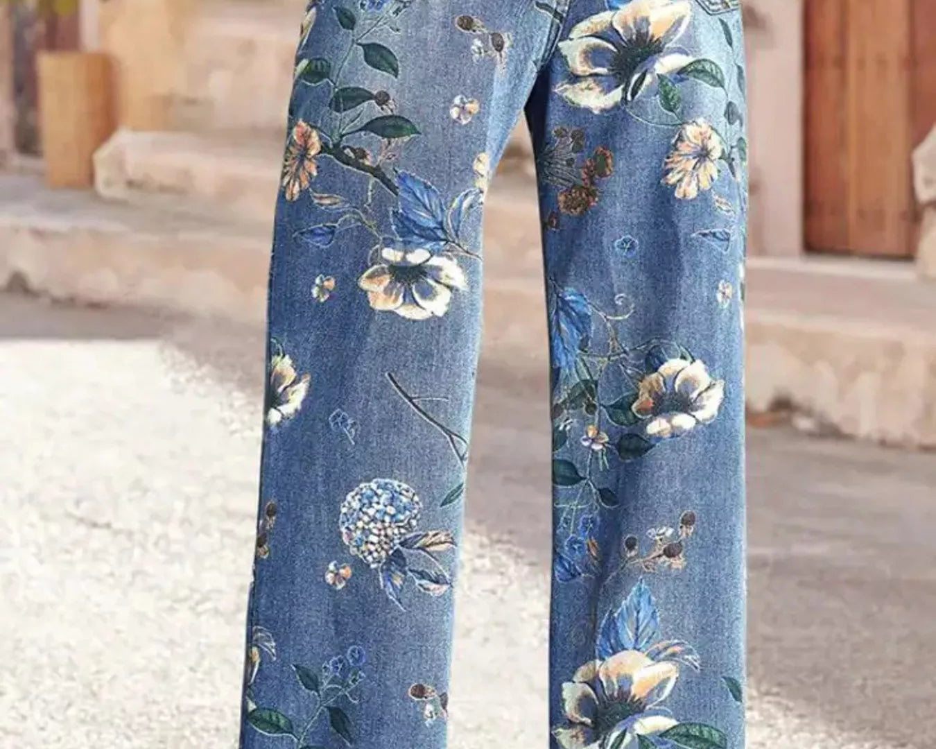 NEWYORKLISTED STYLE COLLECTION: Floral-patterned blue jeans worn by a person on a street.