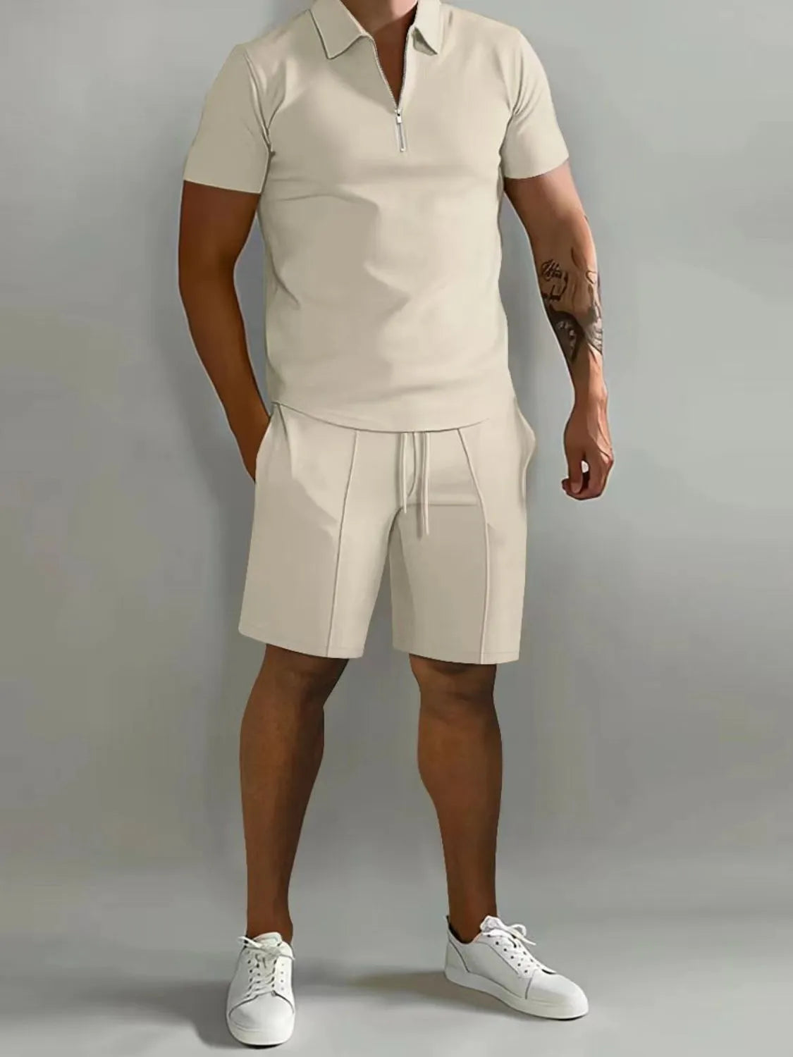 NEWYORKLISTED ATLAS MEN's COLLECTION: Person wearing a beige polo shirt and shorts set with white sneakers on a gray background