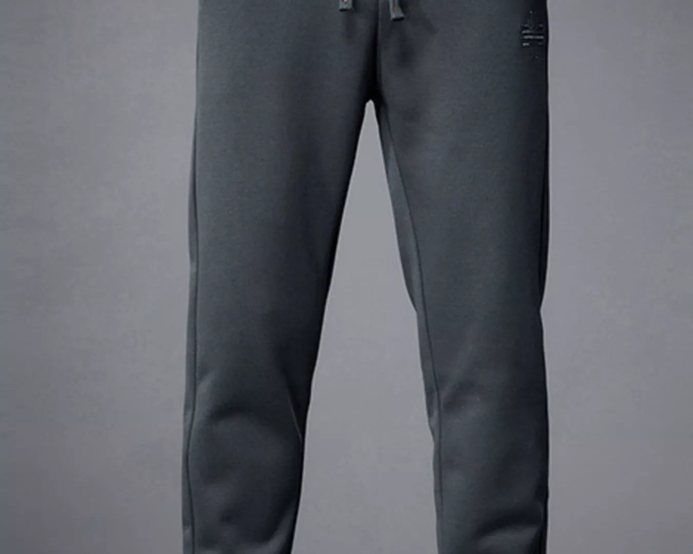 NEWYORKLISTED ATLAS MEN's COLLECTION: Person wearing dark gray jogger pants with a plain background