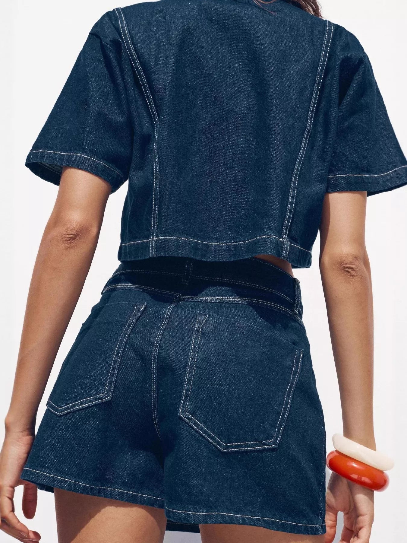 NEWYORKLISTED STYLE COLLECTION: Person wearing a blue denim outfit with a white background