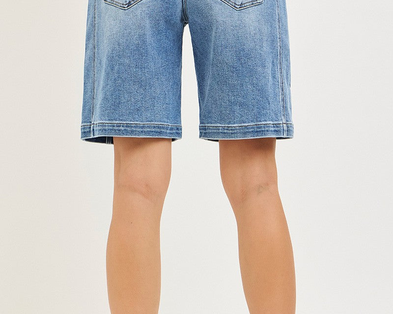 NEWYORKLISTED STYLE COLLECTION: Blue denim shorts worn by a person on a white background