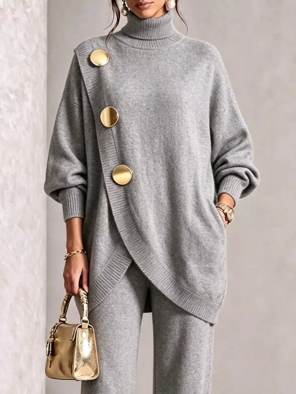 NEWYORKLISTED STYLE COLLECTION: A woman wearing a light gray knit turtleneck sweater with oversized gold buttons and matching gray knit pants, holding a small gold handbag against a neutral indoor background.