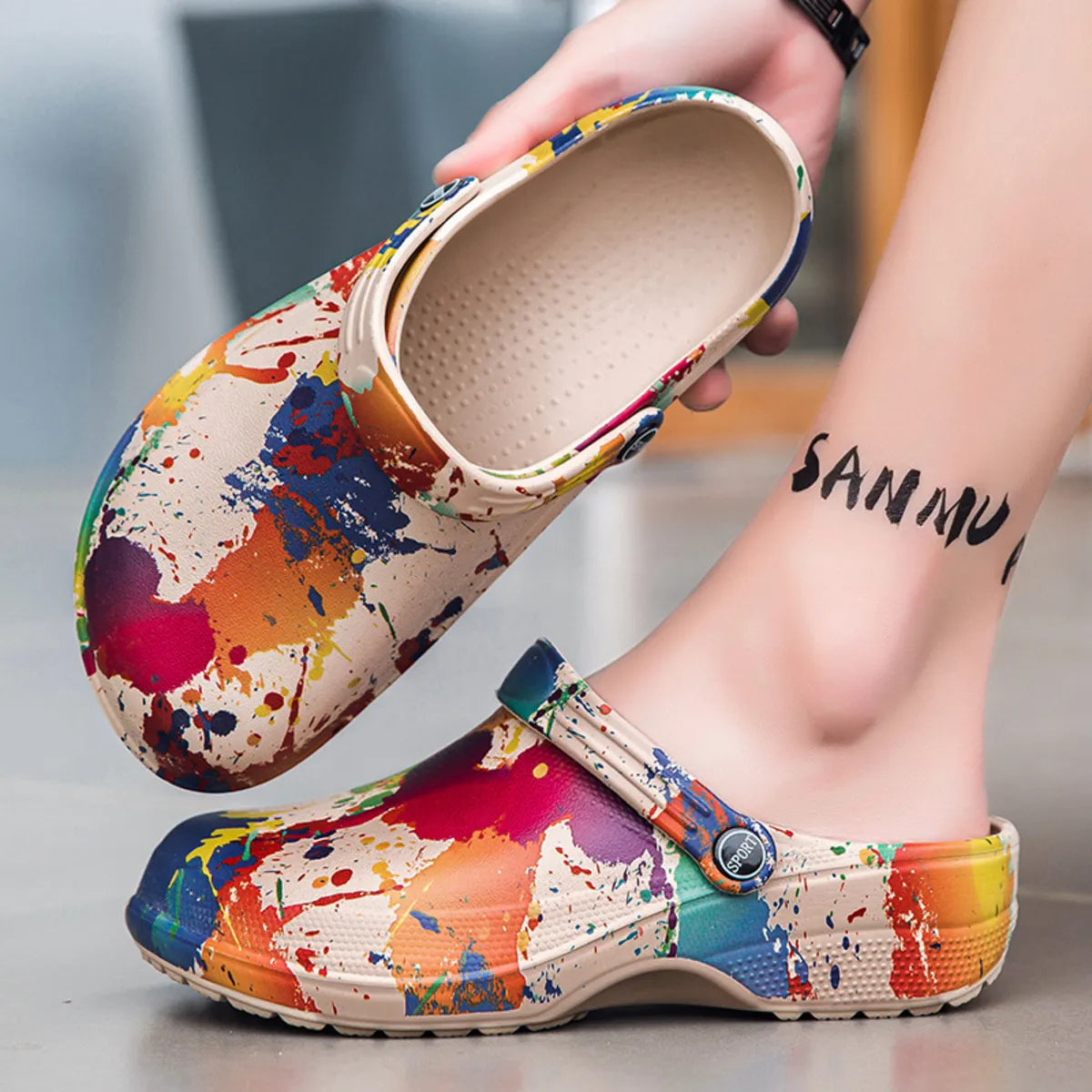 NEWYORKLISTED STYLE COLLECTION: Colorful splatter-patterned clogs being worn with a blurred background