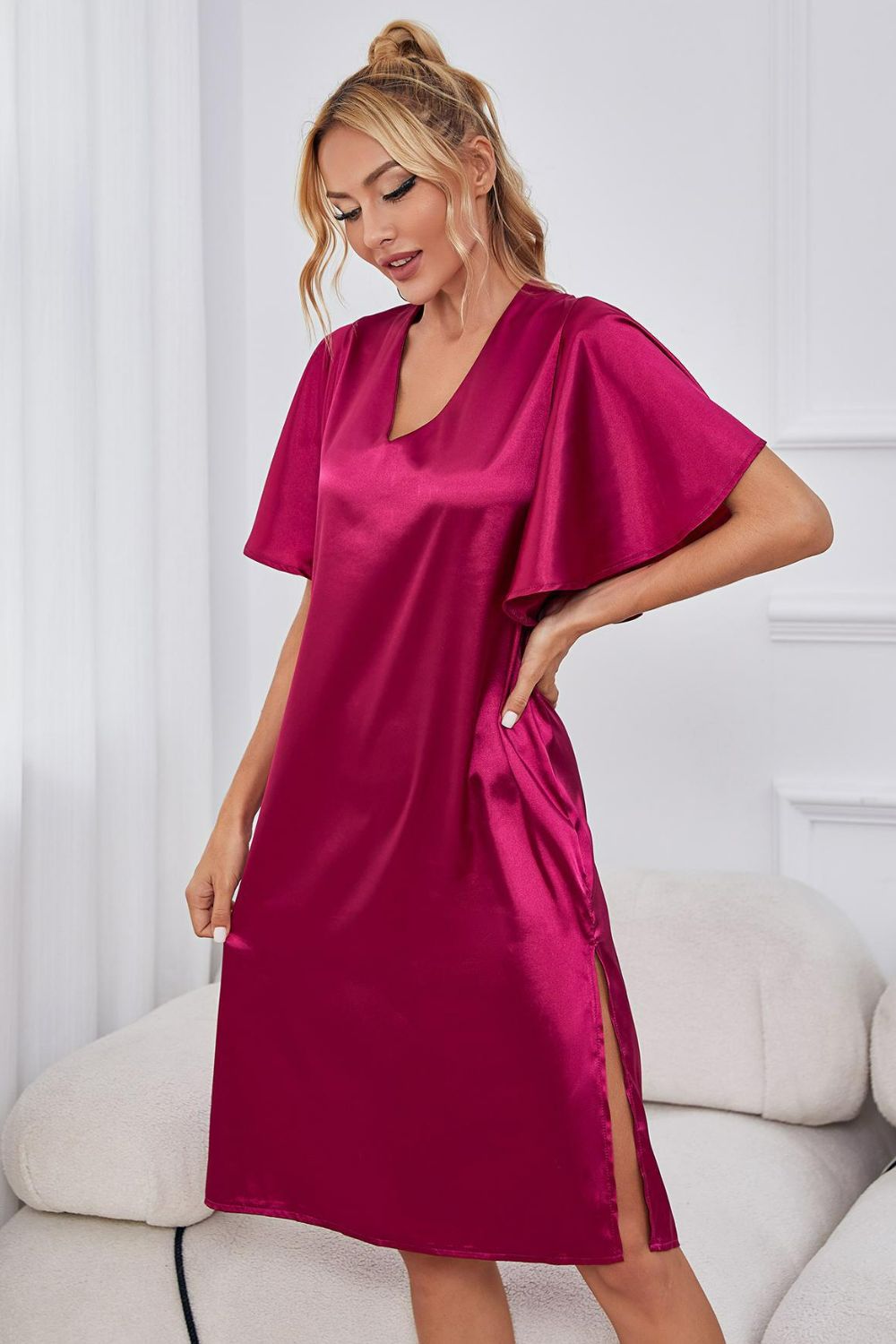 NEWYORKLISTED Intimate Apparel: Woman wearing a pink satin dress in a room with white furniture.