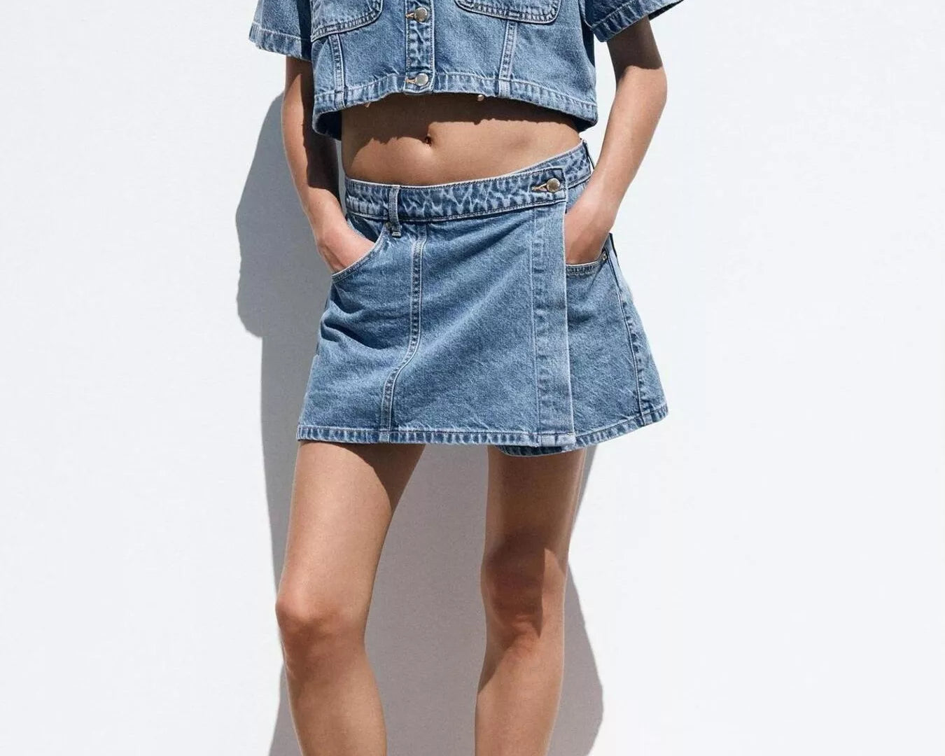 NEWYORKLISTED STYLE COLLECTION: Person wearing a denim outfit with a jacket and skirt on a white background