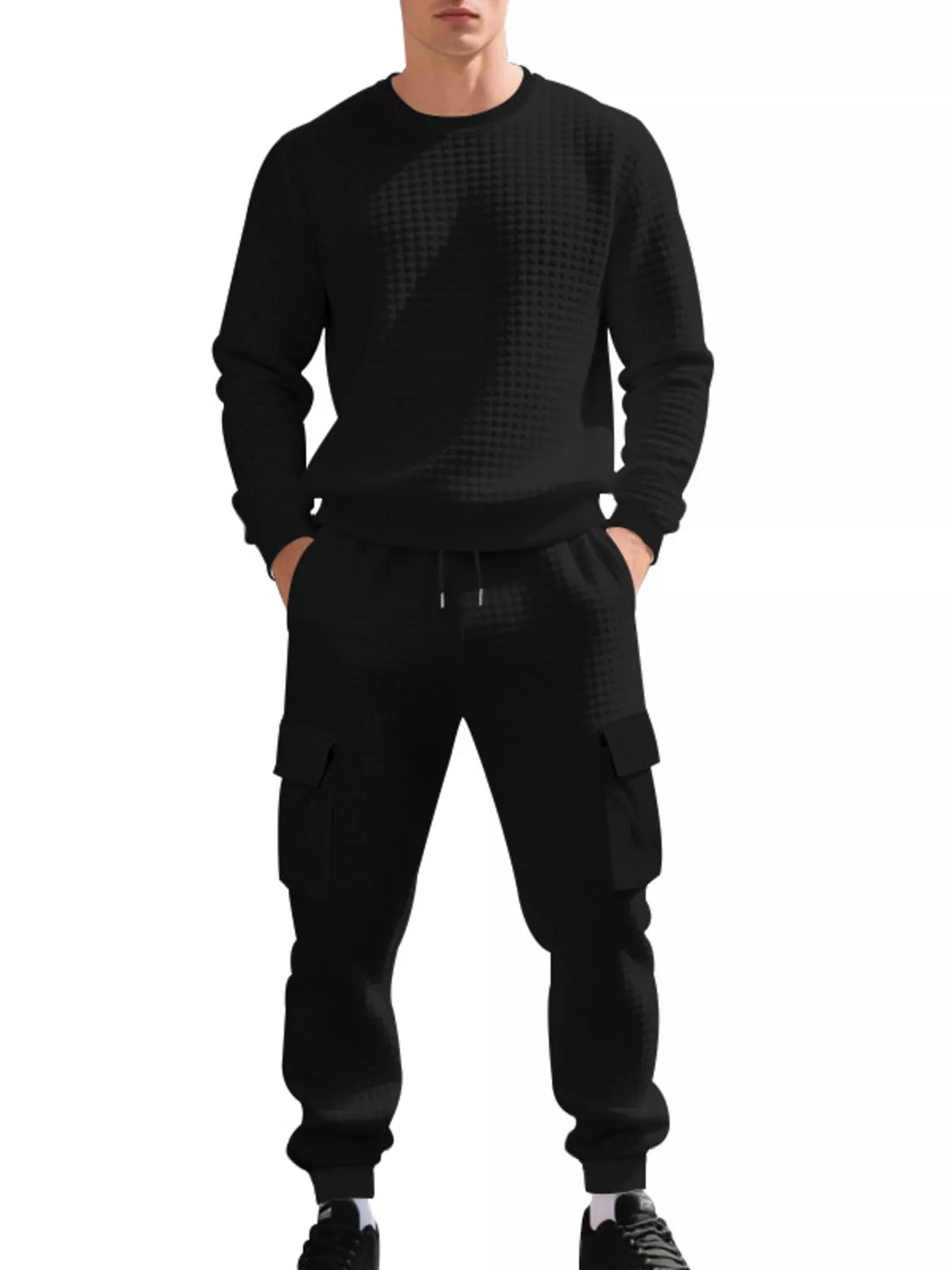NEWYORKLISTED ATLAS MEN'S COLLECTION: A man wearing a black long-sleeve crewneck sweatshirt and matching black cargo jogger pants with a subtle geometric pattern, shown against a plain white background.