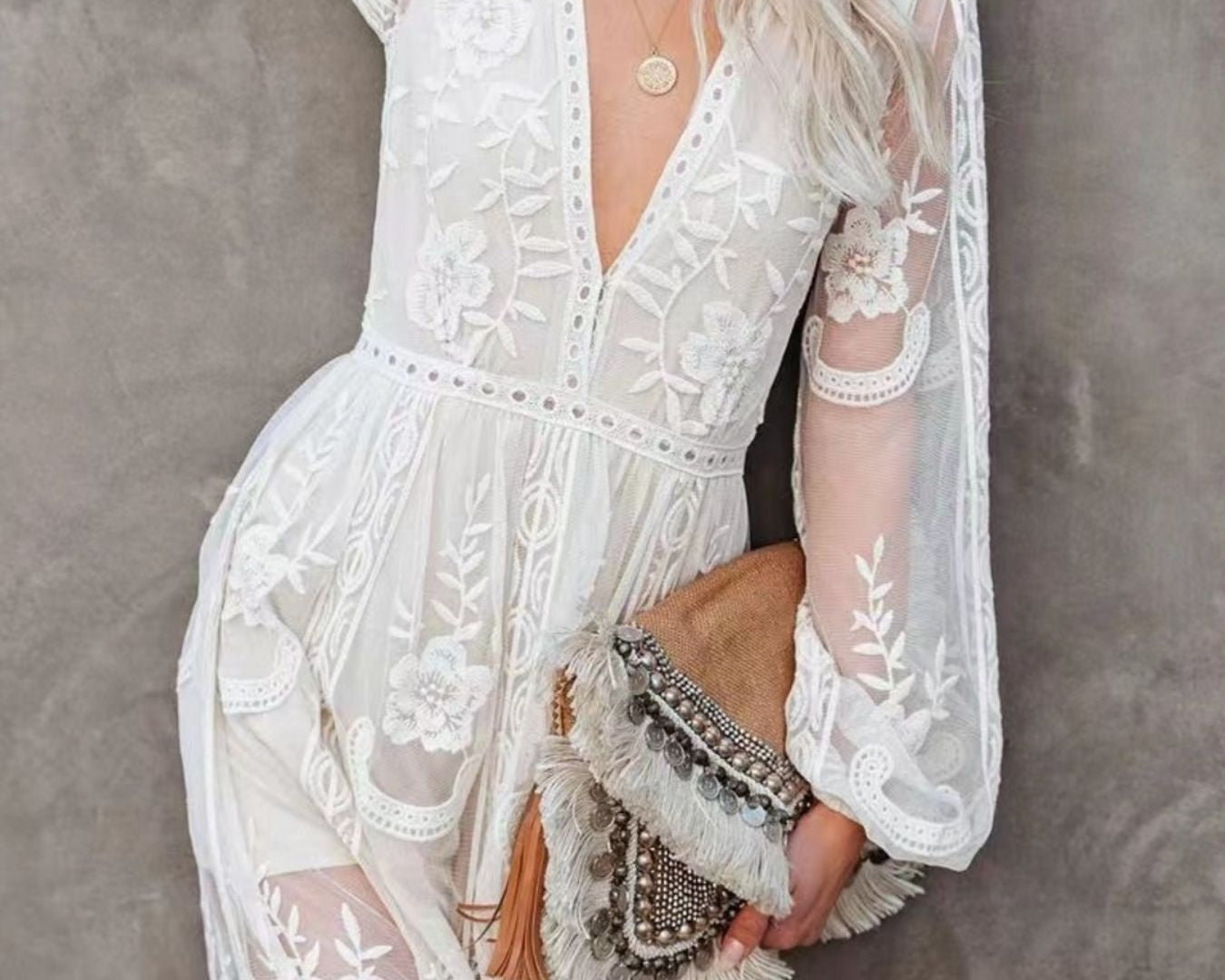 NEWYORKLISTED STYLE COLLECTION: Woman wearing a white lace dress against a gray background