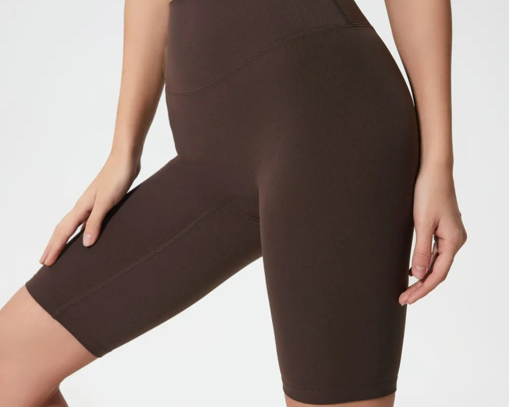 Brown athletic shorts worn by a person on a plain background