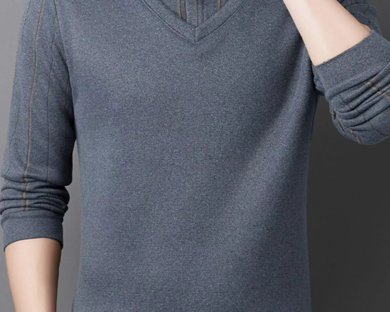 NEWYORKLISTED ATLAS MEN"S COLLECTION: Male model wearing a gray sweater with a collar against a dark background on the NEWYORKLISTED.COM website.