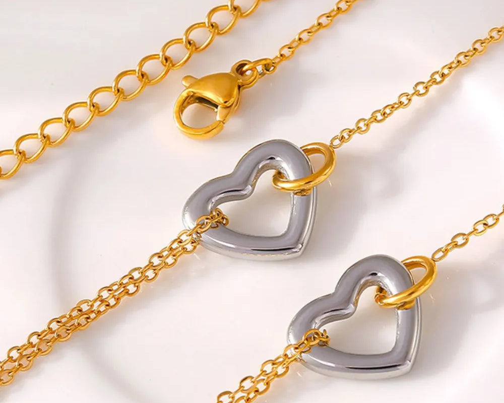 NEWYORKLISTED Valentine's Day Specials: Gold and silver heart-shaped clasp on a gold chain against a white background