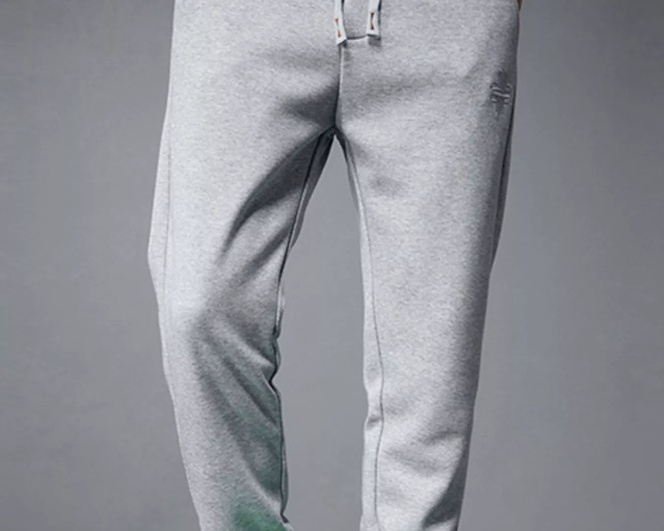 NEWYORKLISTED ATLAS MEN's COLLECTION: Person wearing gray sweatpants and green sneakers on a gray background