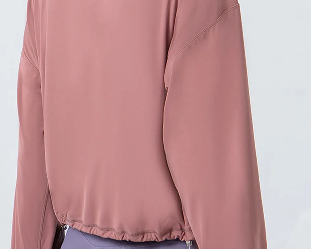 NEWYORKLISTED ACTIVEWEAR COLLECTION: Person wearing a pink jacket and purple leggings on a white background