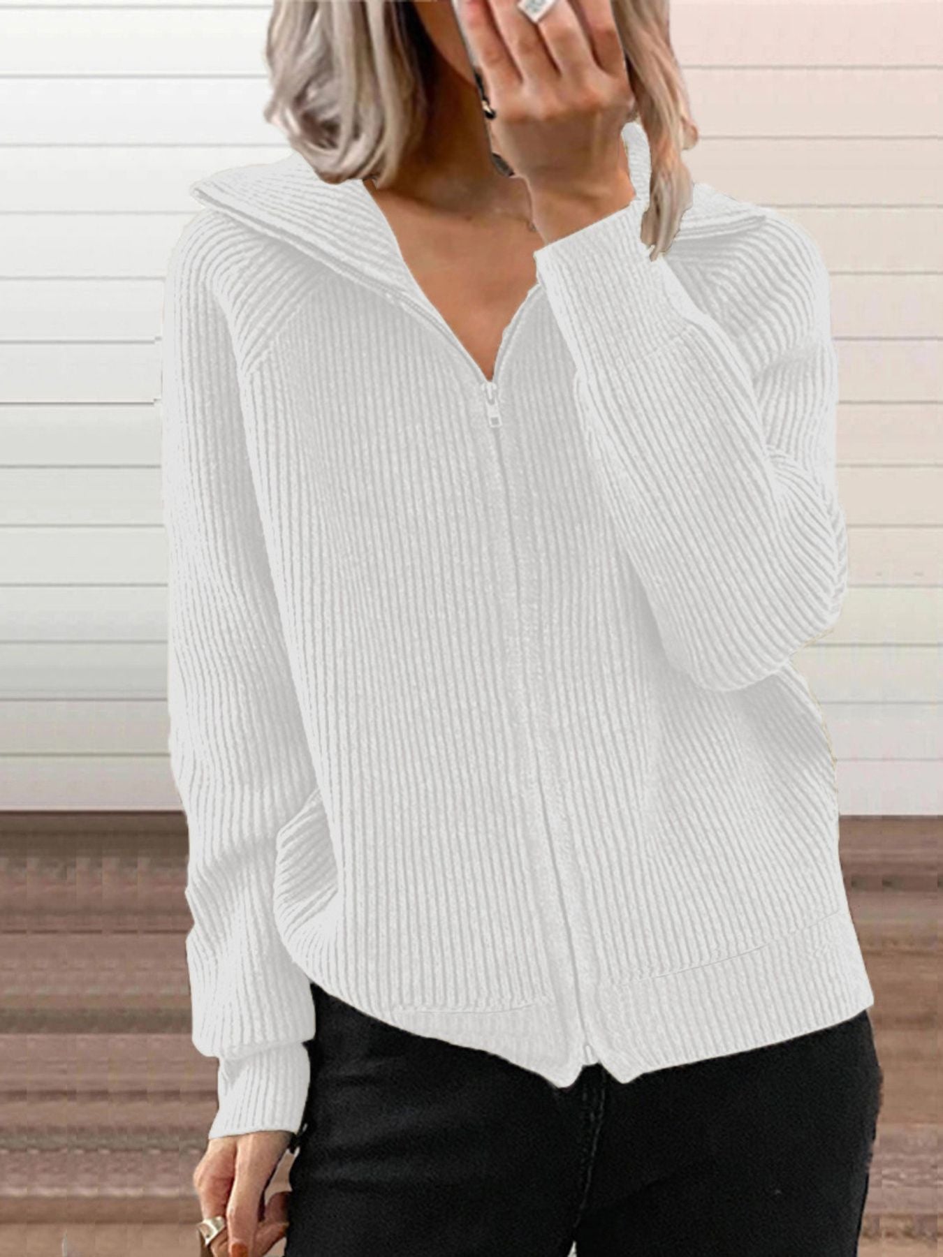 NEWYORKLISTED STYLE COLLECTION: White ribbed sweater worn by a person with a neutral background