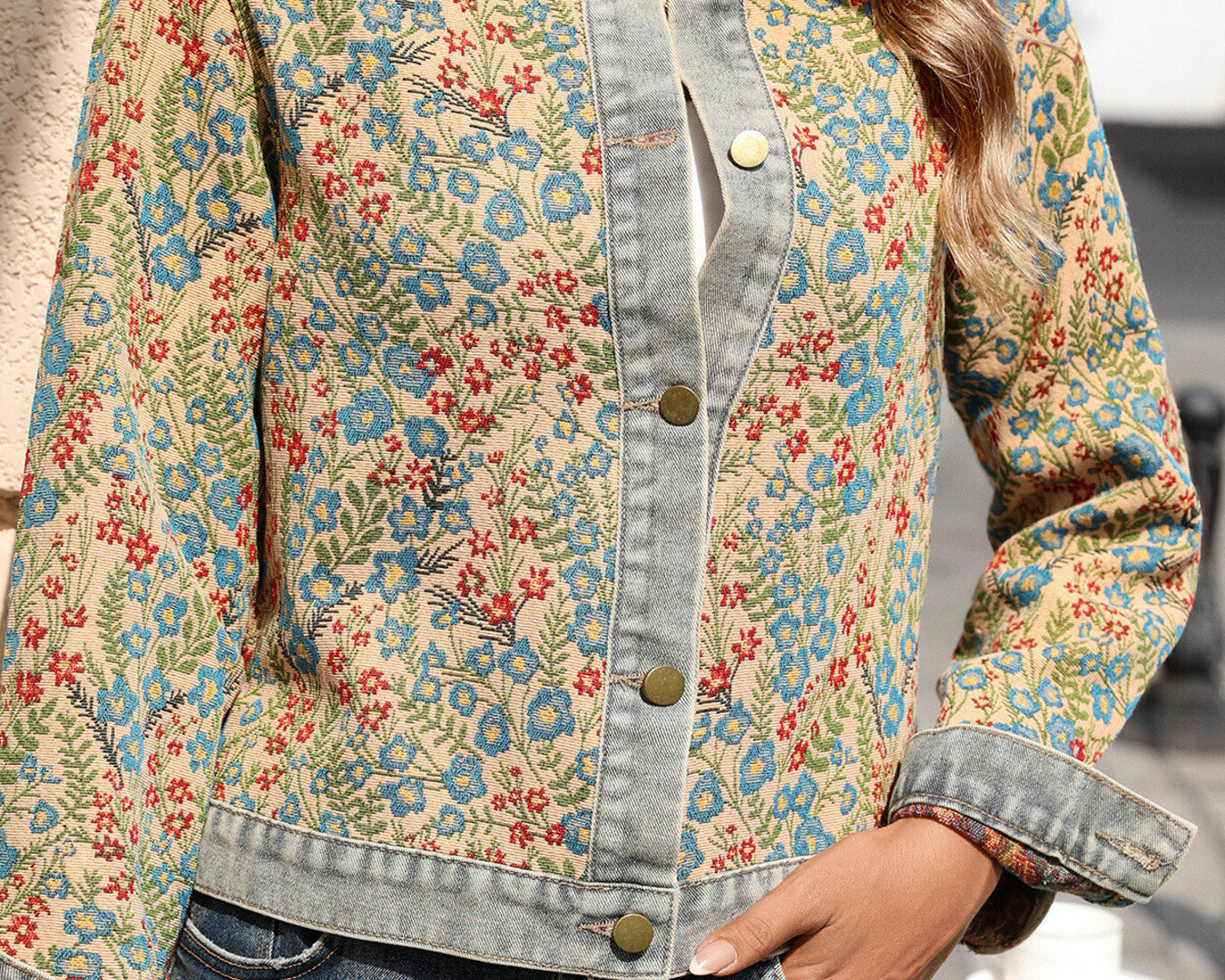NEWYORKLISTED STYLE COLLECTION: Person wearing a floral denim jacket with a blurred background