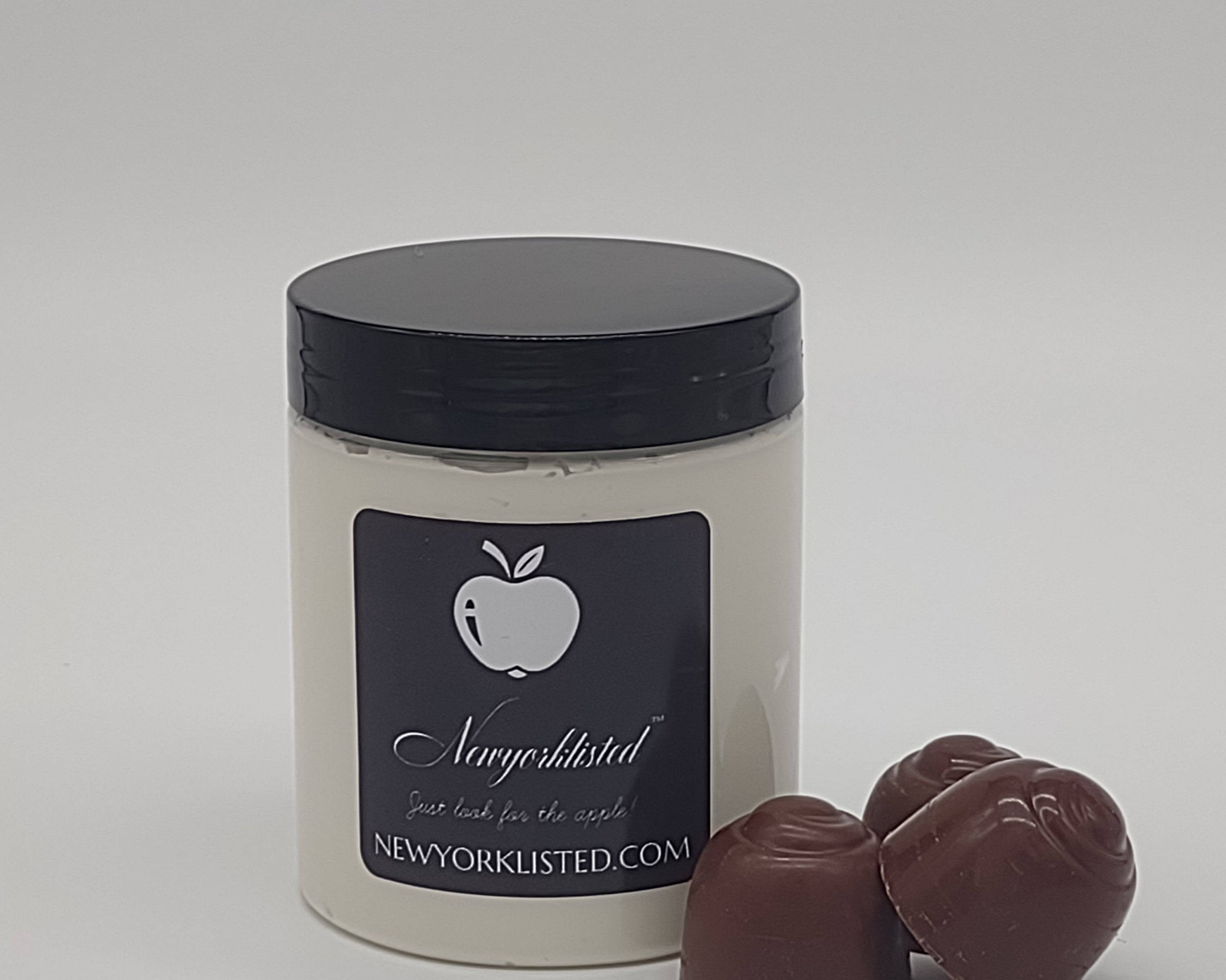 NEWYOPKLISTED Whipped Cocoa Dreams Body Butter shown in 6 oz jar with chocolates.