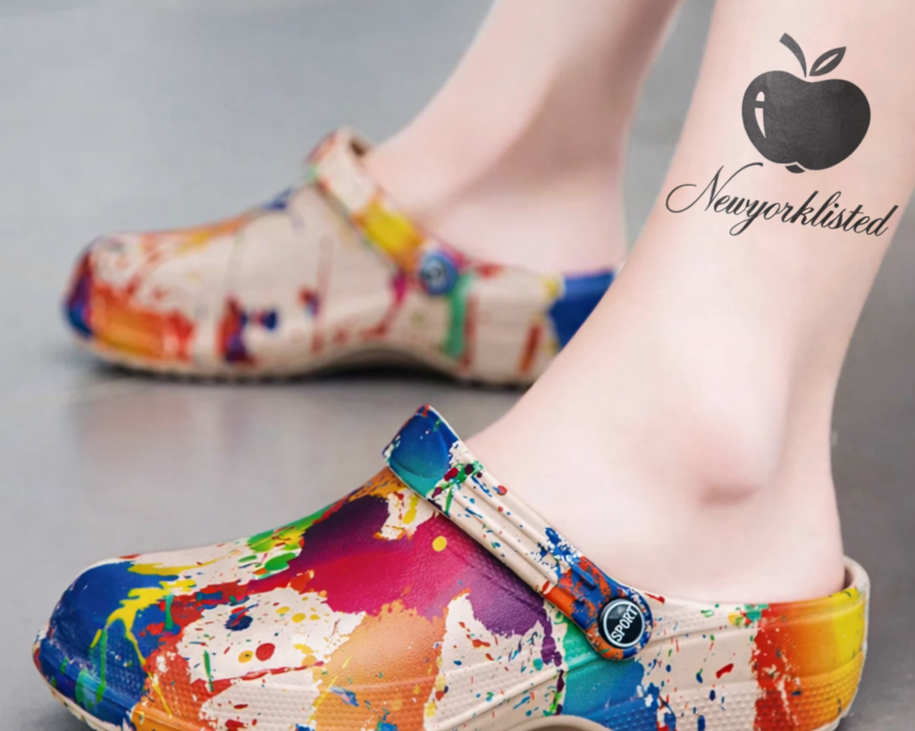 NEWYORKLISTED SHOE COLLECTION: Colorful splatter-patterned clogs worn by a person with a visible tattoo on their leg.