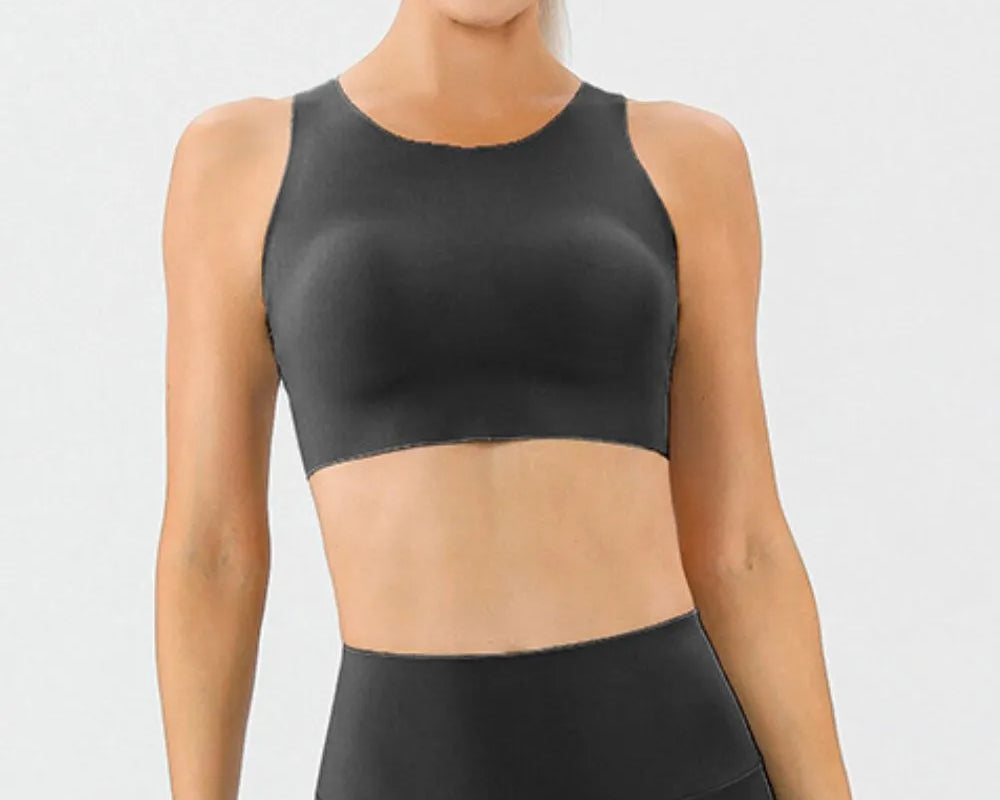 NEWYORKLISTED ACTIVEWEAR COLLECTION: Woman wearing a black athletic outfit on a white background