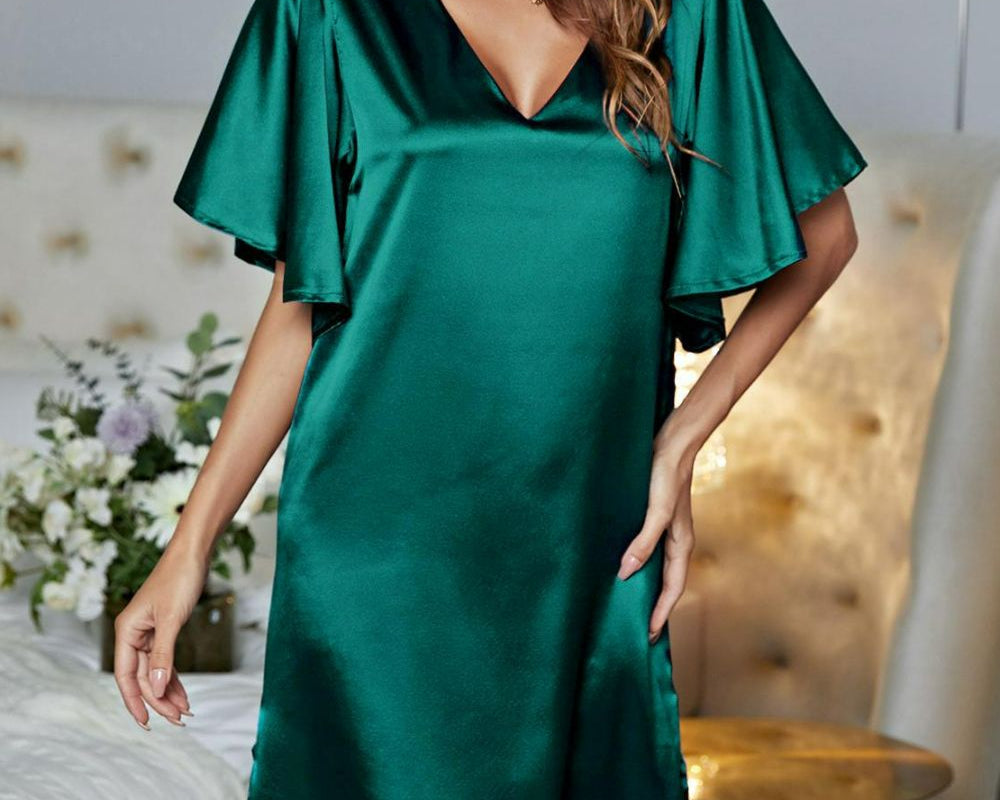 NEWYORKLISTED Intimate Apparel: Woman wearing a green satin dress in a bedroom setting