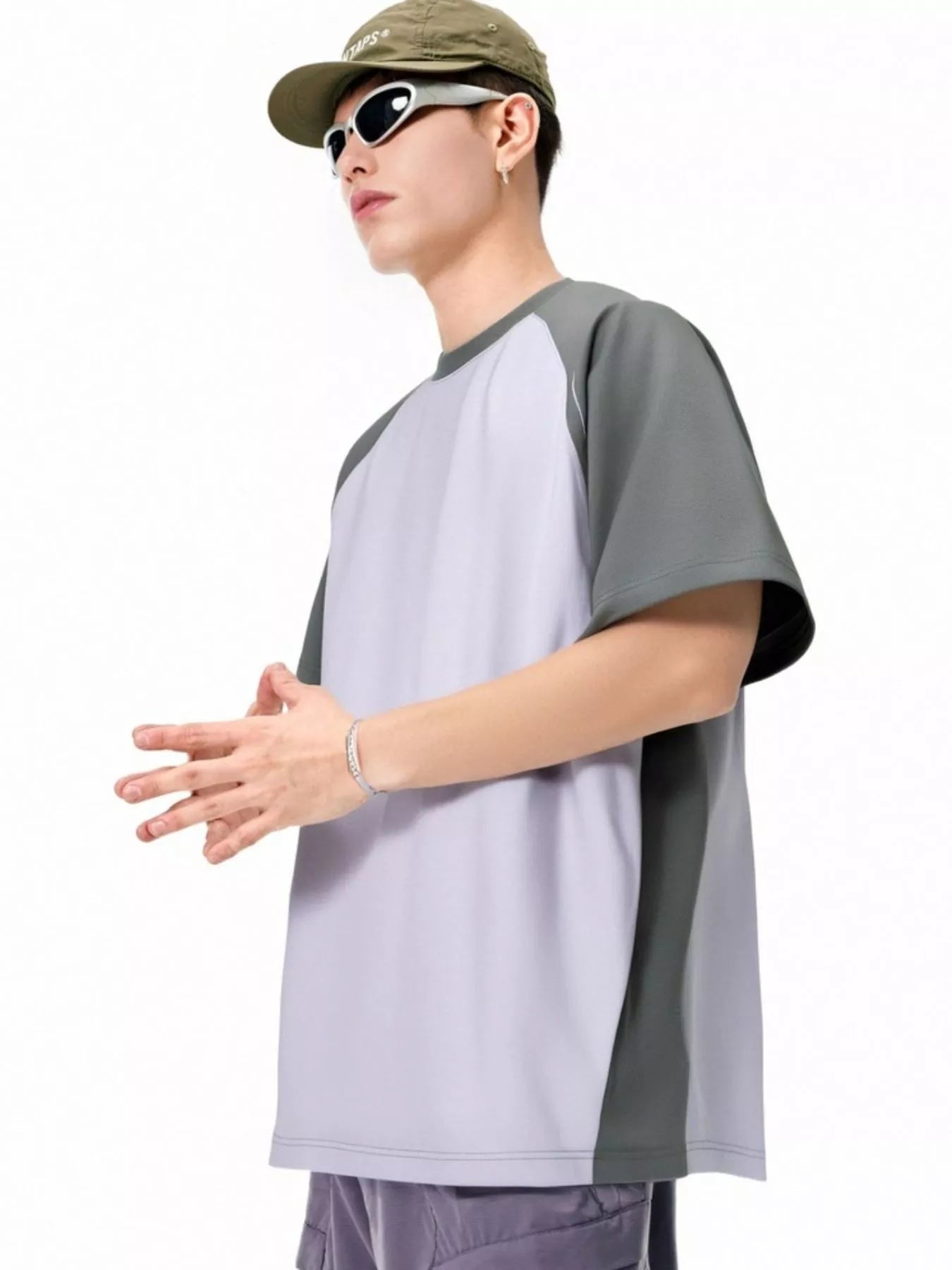 NEWYORKLISTED ATLAS MEN's COLLECTION: Person wearing a gray and white shirt with a cap and sunglasses on a white background