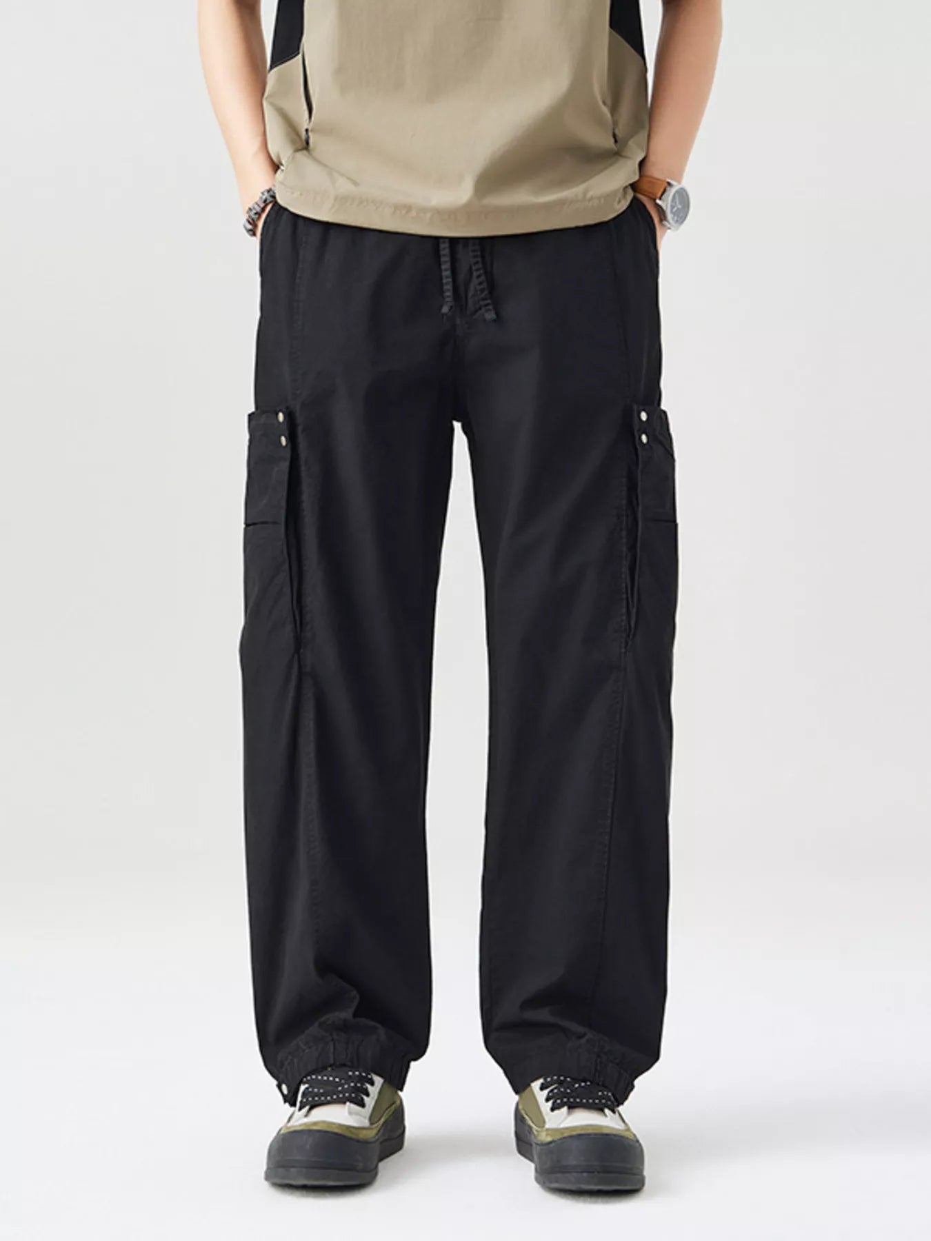 NEWYORKLISTED ATLAS MEN's COLLECTION: Person wearing black cargo pants on a white background