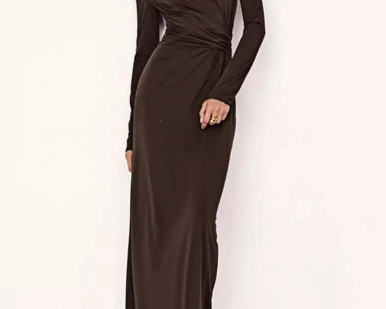 NEWYORKLISTED STYLE COLLECTION: Woman wearing a long brown dress against a white background