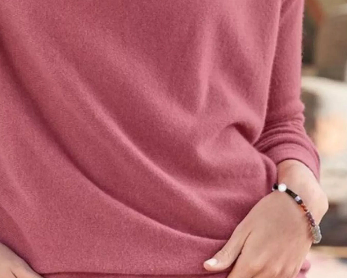 NEWYORKLISTED STYLE COLLECTION: Person wearing a pink long-sleeve shirt and blue jeans with a blurred background