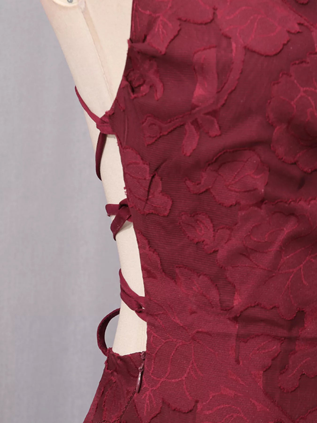 NEWYORKLISTED STYLE COLLECTION: Red lace dress on a mannequin against a gray background
