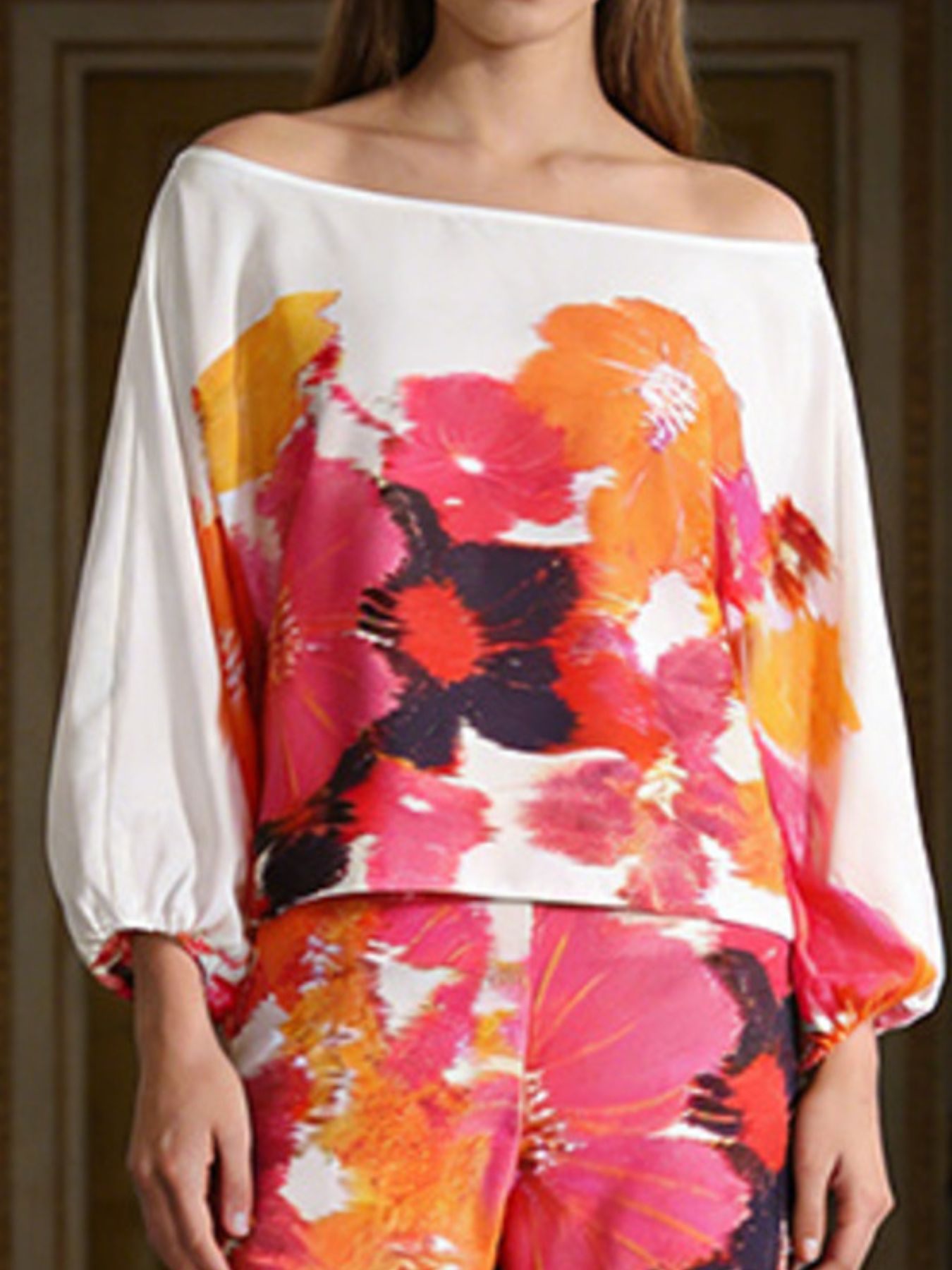 NEWYORKLSITED STYLE COLLECTION: Floral off-shoulder top with colorful design on a plain background