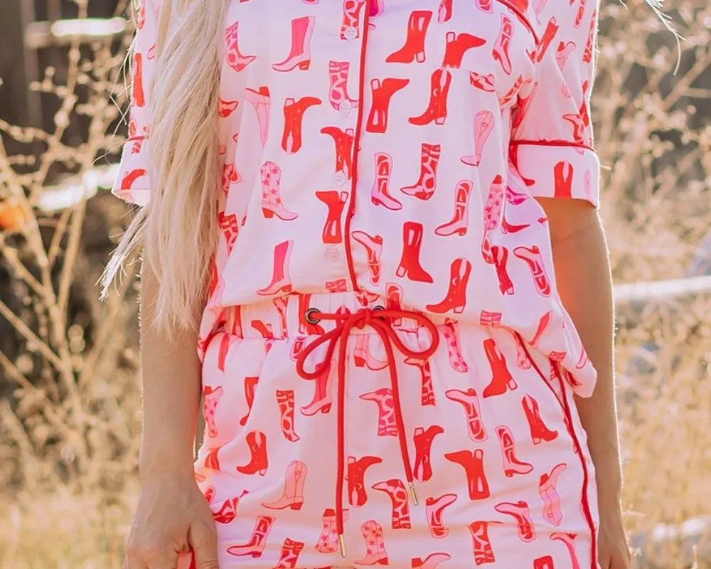 NEWYORKLISTED Intimate Apparel: Woman wearing a pink and red patterned romper with a blurred outdoor background