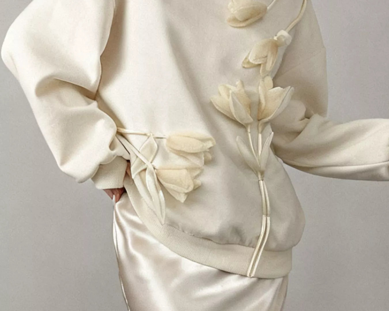 NEWYORKLISTED STYLE COLLECTION: White outfit with floral details on a plain background