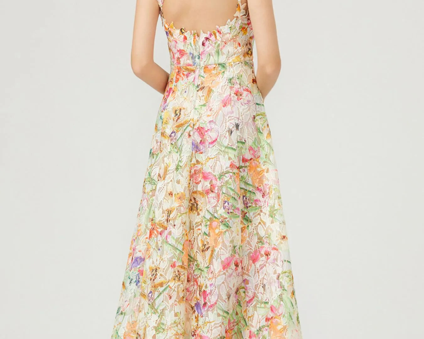 NEWYORKLISTED STYLE COLLECTION: Woman wearing a floral dress on a white background