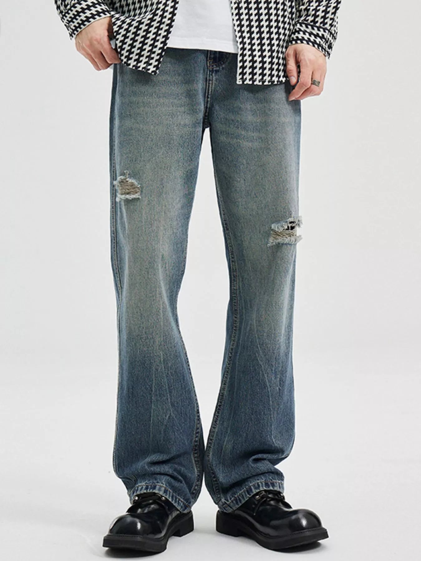 NEWYORKLISTED ATLAS MEN's COLLECTION: Person wearing ripped blue jeans and a checkered shirt on a white background