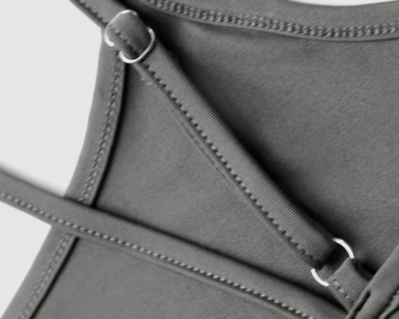 Gray swimsuit with thin straps on a light gray background