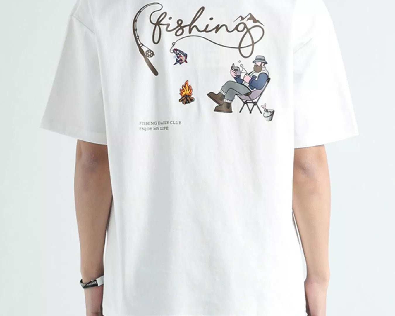 Person wearing a white t-shirt with a fishing-themed graphic on the back.