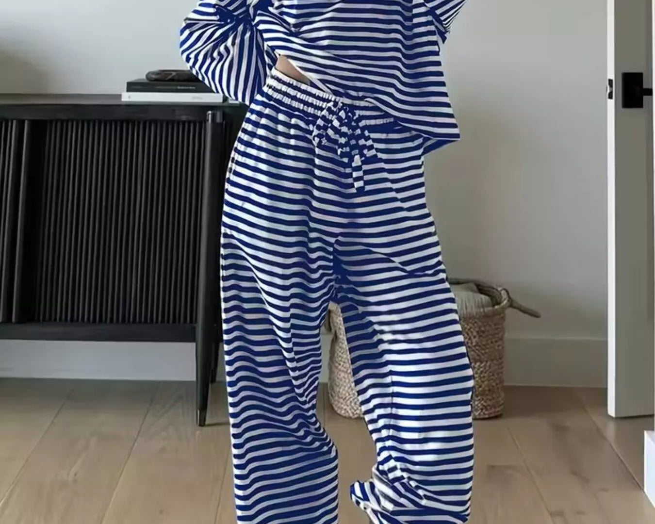NEWYORKLISTED Comfort Collection: Person wearing a blue and white striped outfit with gray boots indoors.