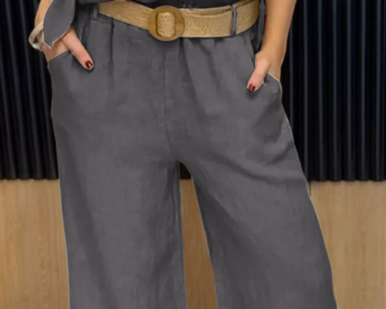 NEWYORKLISTED COMFORT COLLECTION: Person wearing a gray outfit with a belt in an indoor setting