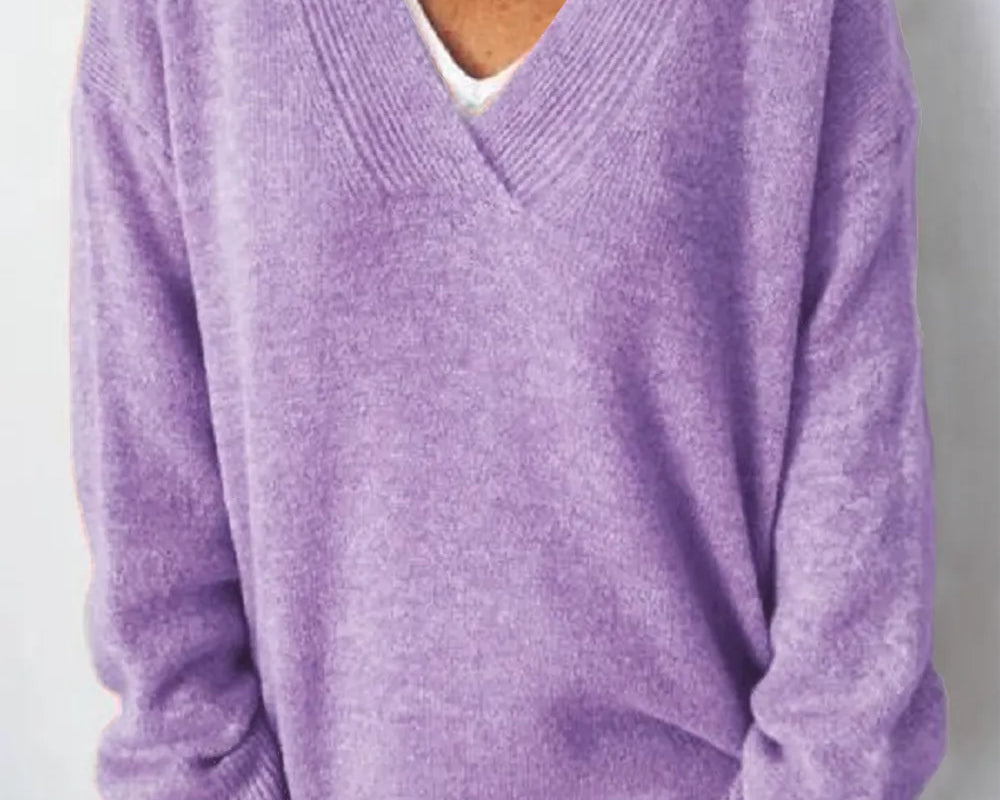 NEWYORKLISTED STYLE COLLECTION: Person wearing a purple sweater against a white background