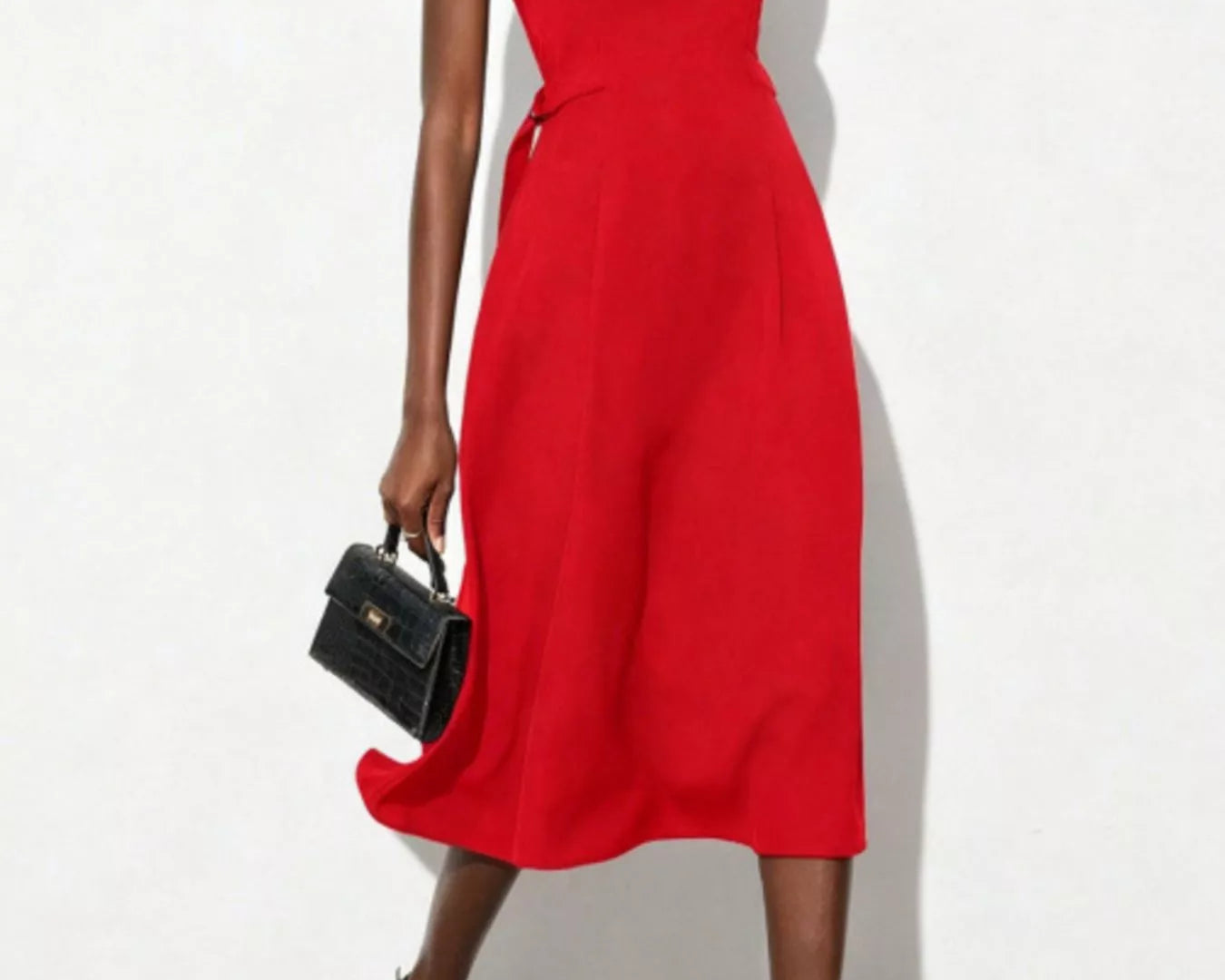 NEWYORKLISTED STYLE COLLECTION: Red sleeveless dress worn by a model on a white background