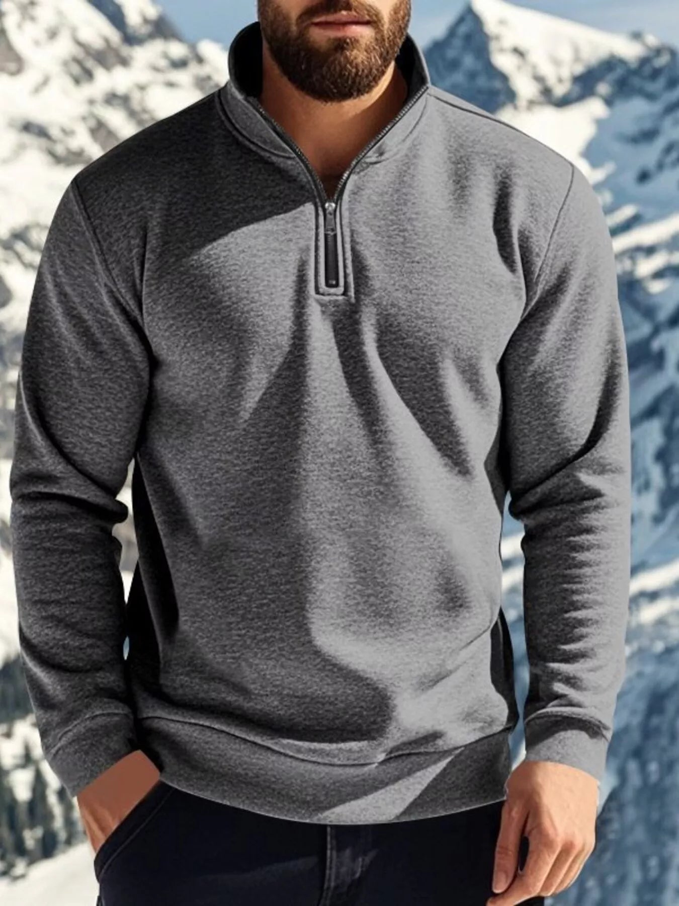 NEWYORKLISTED ATLAS MEN'S COLLECTION: Person wearing a gray half-zip pullover with a mountainous background