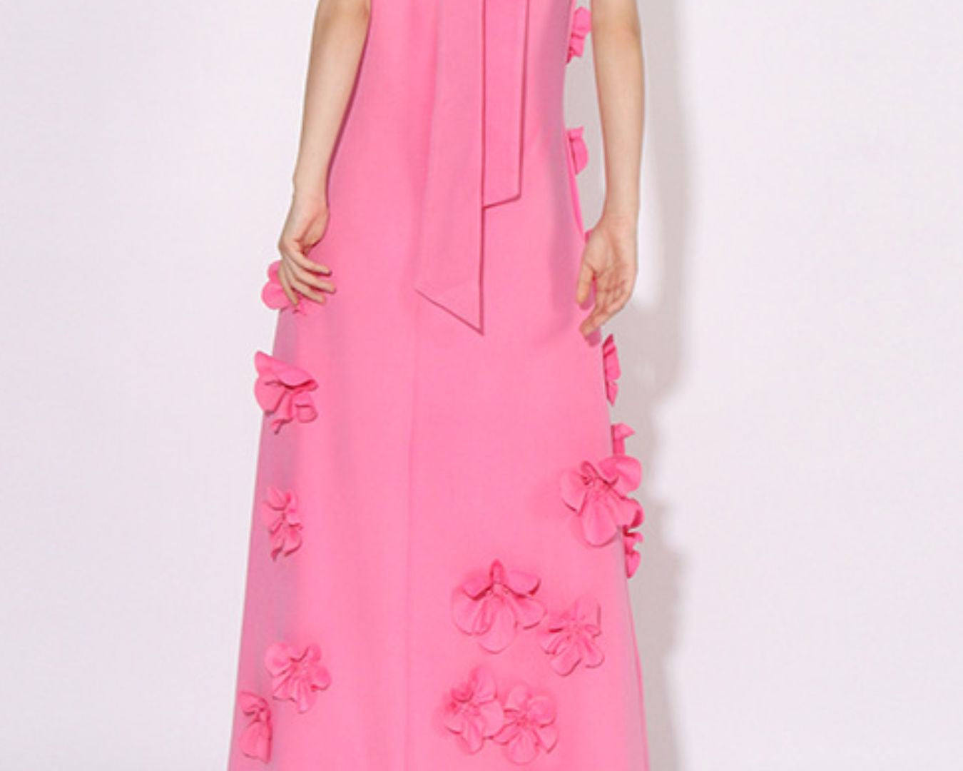 NEWYORKLISTED STYLE COLLECTION: Pink dress with floral embellishments on a white background