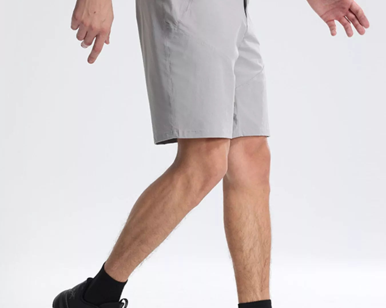 NEWYORKLISTED ATLAS MEN's COLLECTION: Person wearing gray shorts and black shoes on a white background
